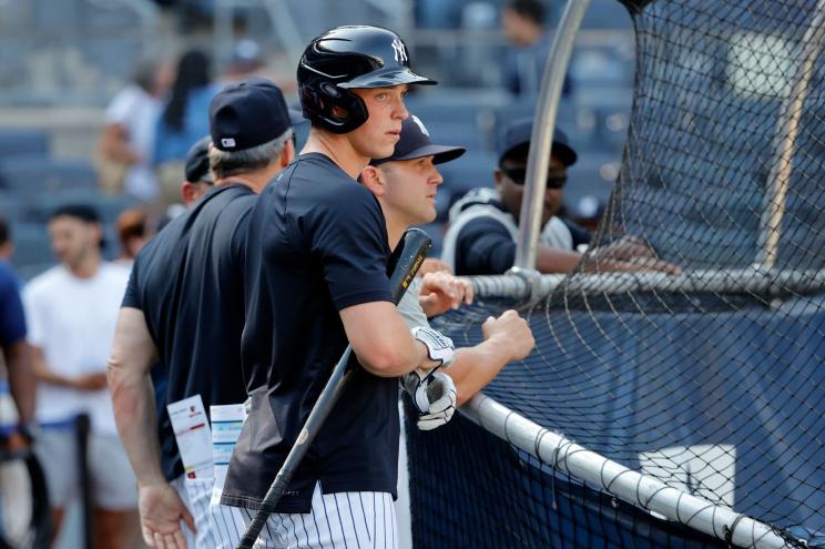 Rookie first baseman Ben Rice practicing in the batting cage with his coaching staff at Yankee Stadium before his major league debut game