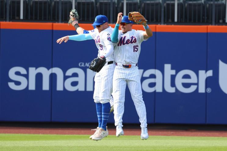 Mets outfielders jump to celebrate a win over the Padres on June 16, 2024.