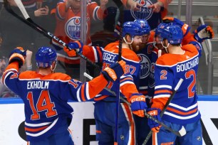 Connor McDavid (wearing the captain's C) is mobbed by teammates after scoring a second period goal in the Oilers' 8-1 blowout win over the Panthers in Game 4 of the Stanley Cup Finals.