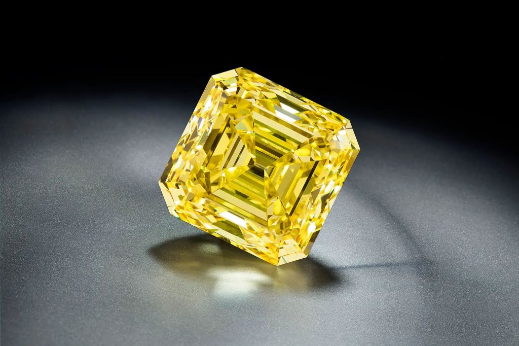 A yellow diamond on a black surface