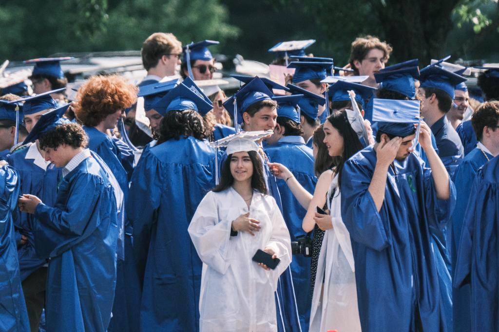 Graduates in caps and gowns outside Newtown High School's graduation.