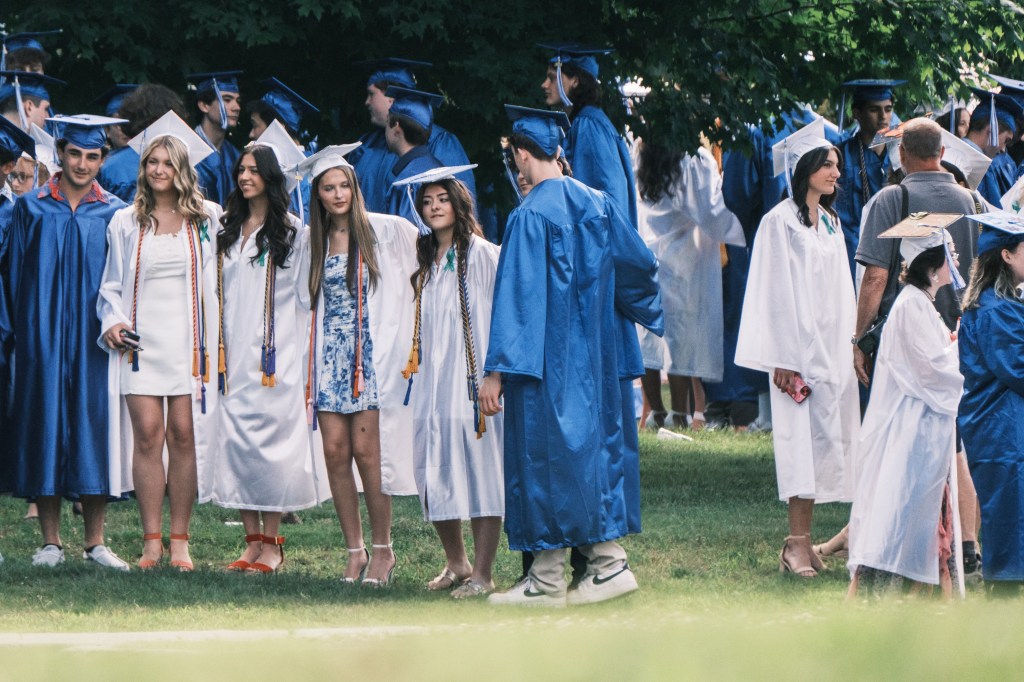 Graduates in caps and gowns outside Newtown High School's graduation.