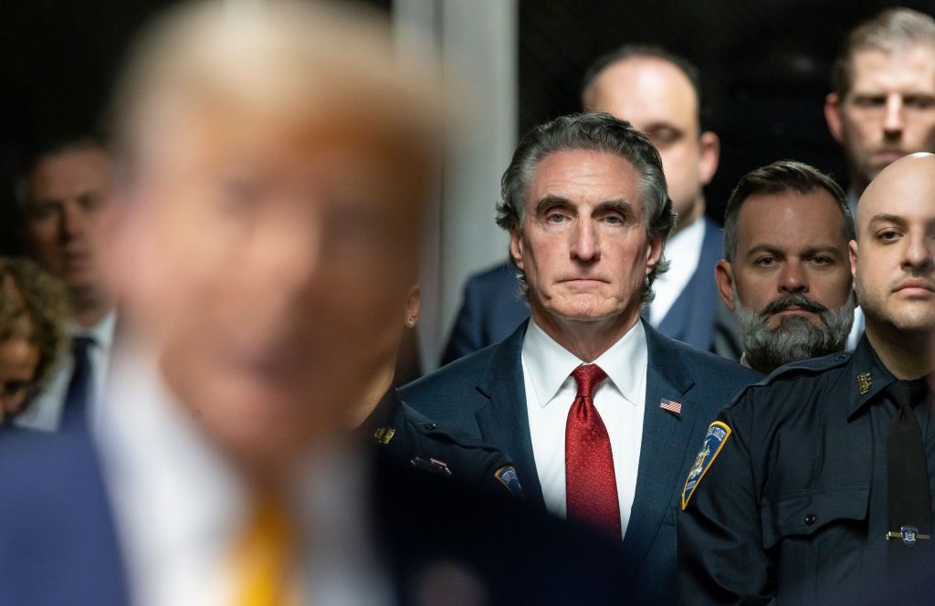 Former US President Donald Trump speaking to reporters outside the courtroom with North Dakota Governor Doug Burgum listening attentively