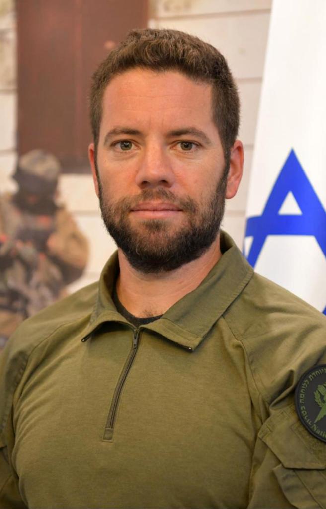 Portrait of Chief Inspector Arnon Zmora from the Yamam elite counter-terrorism unit in a green shirt, who died during a rescue operation i