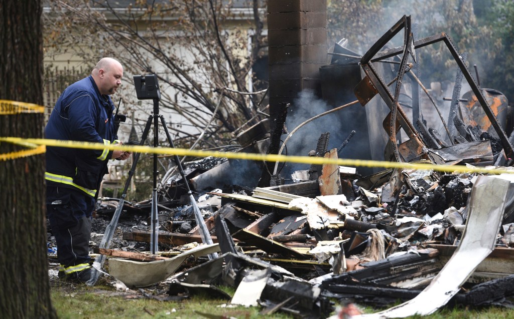 The body of an adult male was pulled out from the smoldering debris.