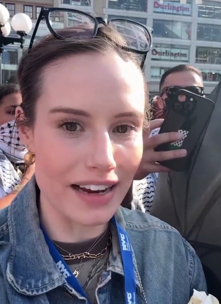 Olivia Reingold, of The Free Press, took footage of her being encircled by demonstrators who wanted her to leave the area.