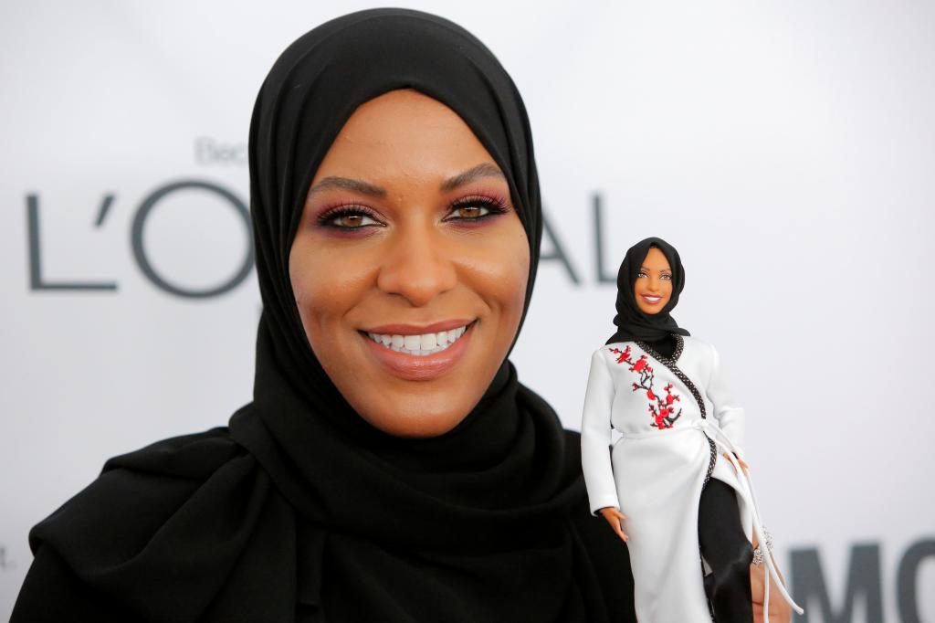 Olympic fencer Ibtihaj Muhammad holds a Barbie doll.