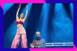 Sofi Tukker on stage in a blue and pink border