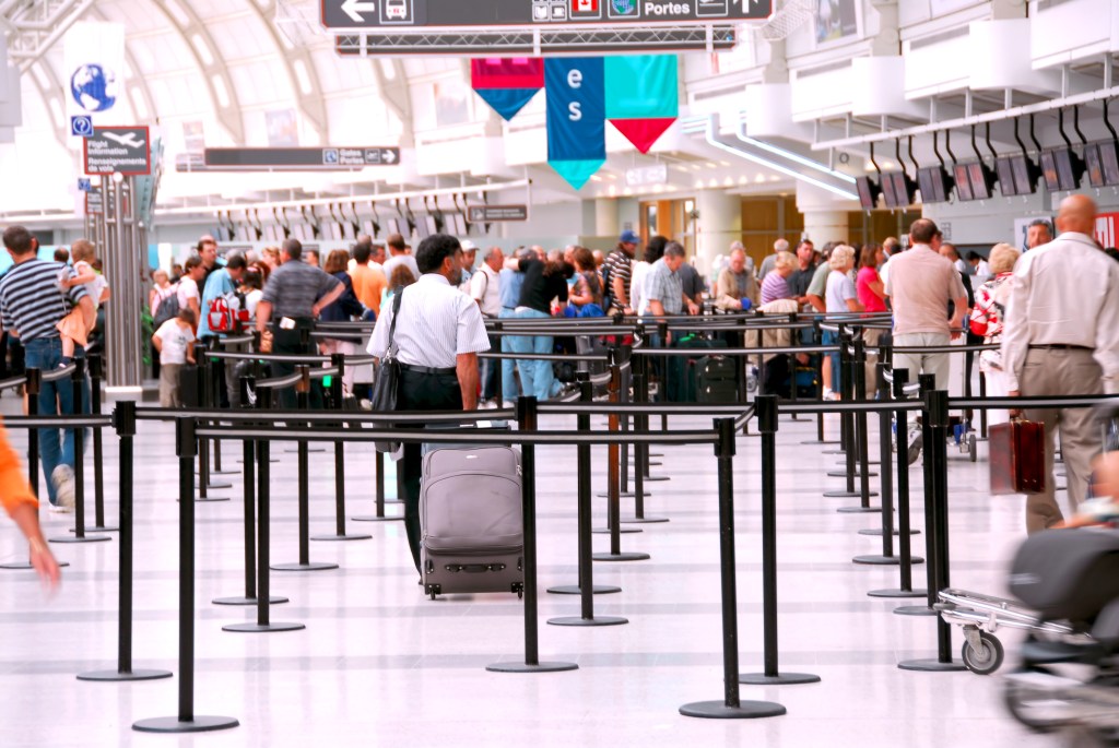 Passengers lining up at check-in counter at the modern international airport