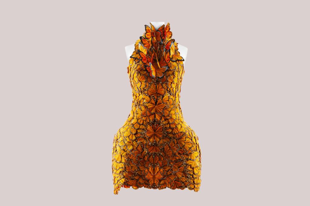 A mannequin displaying a dress made entirely of butterflies