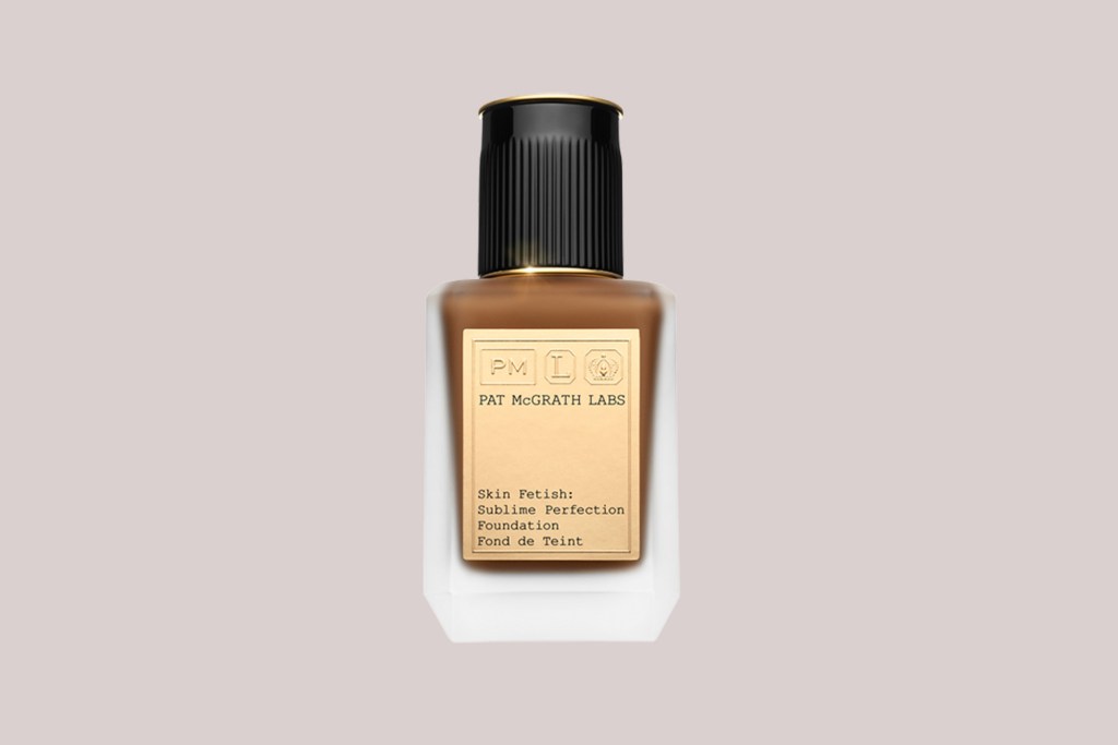 A bottle of liquid foundation with a black lid