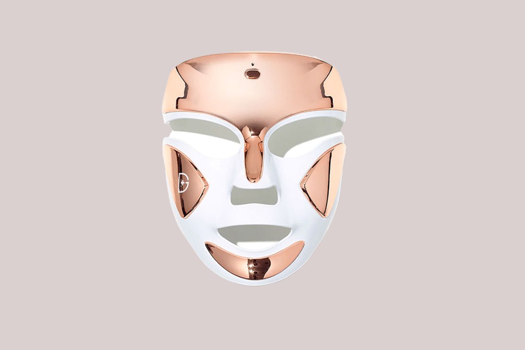 A white and gold face mask