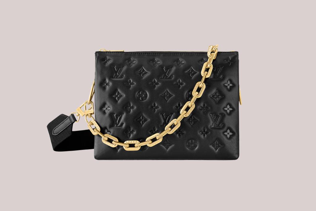 A black purse with a gold chain