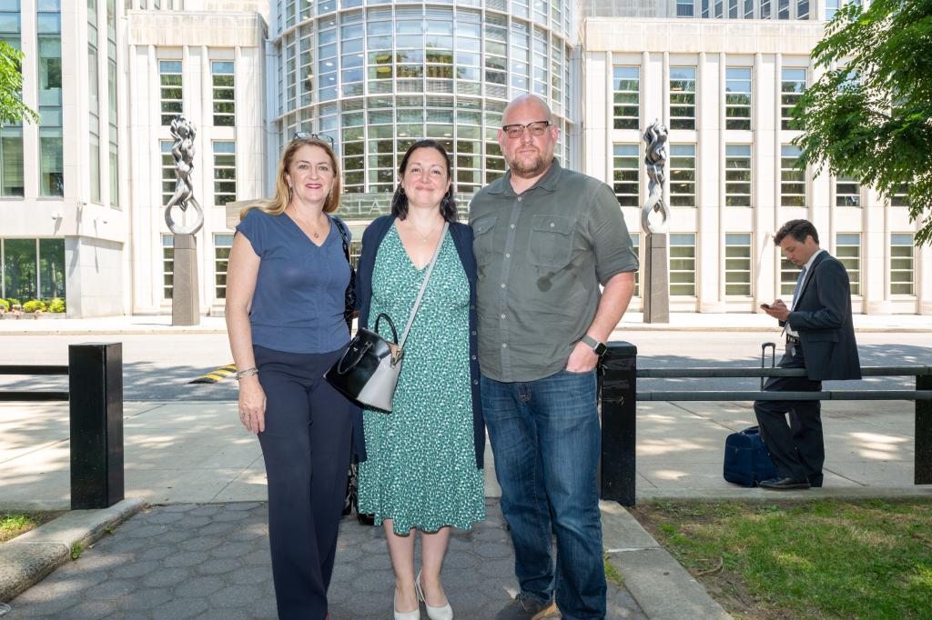 Maud Maron in blue shirt, Noah Harlan, and Deborah Alexander in green dress, plaintiffs in a lawsuit against CEC 14's Tajh Sutton, posing for a photo together