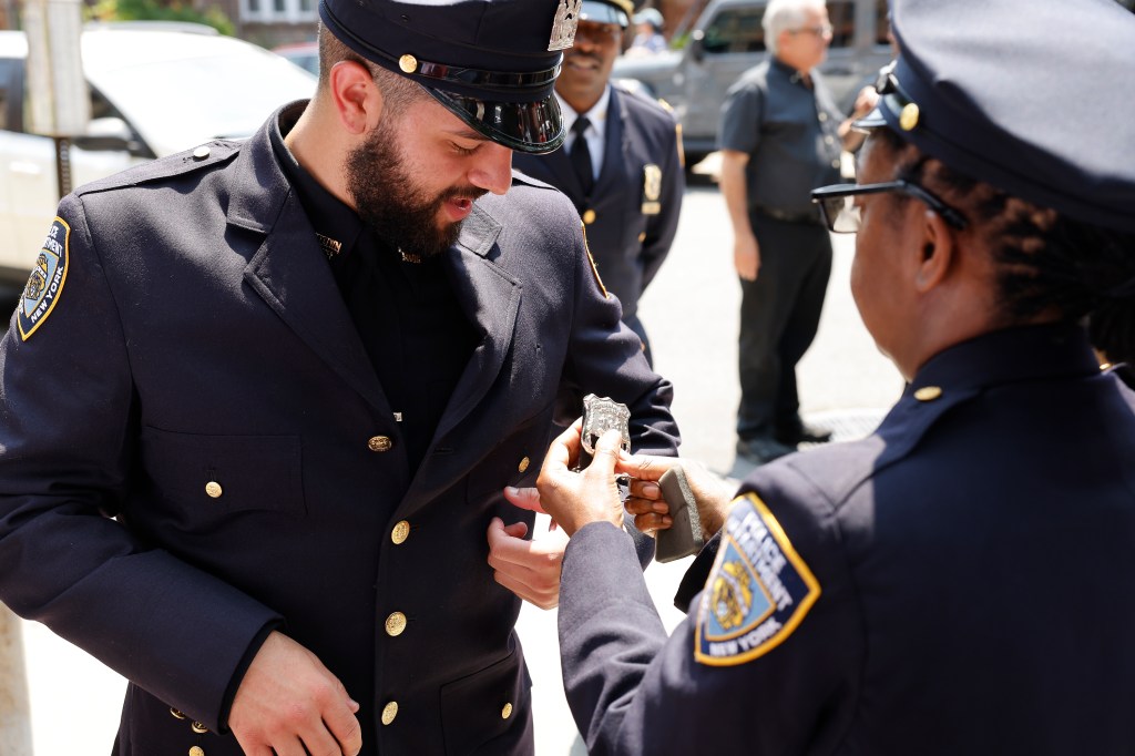 Police officer helps killed cop's grandson don shield.