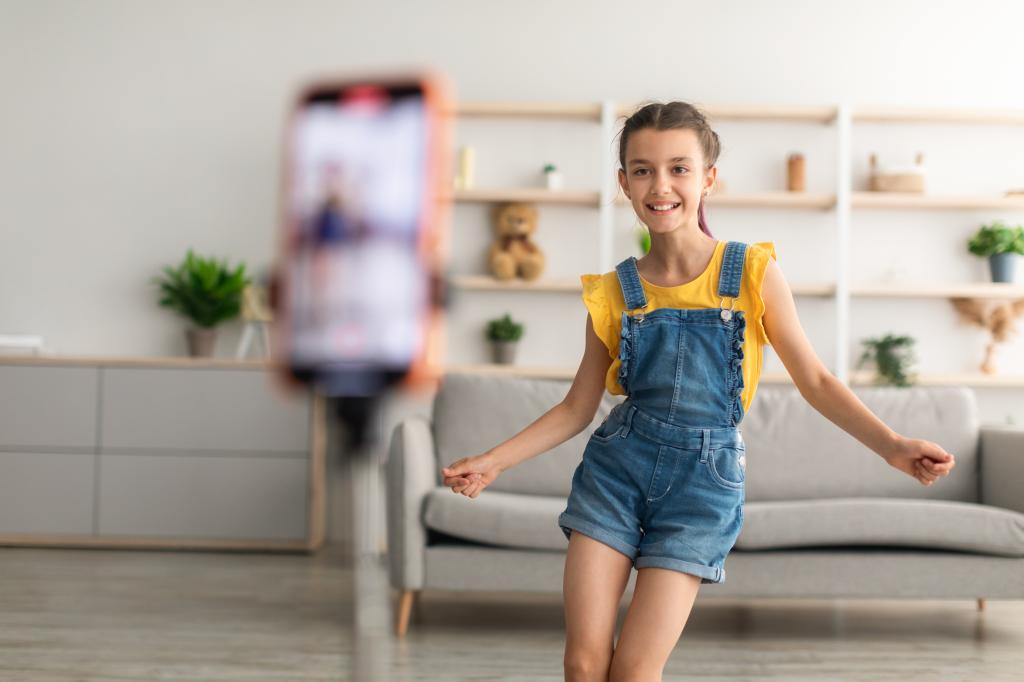 Little girl dancing on camera, in a living room