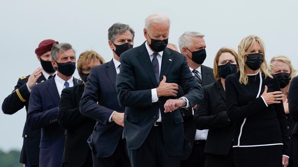 President Biden checks his watch
