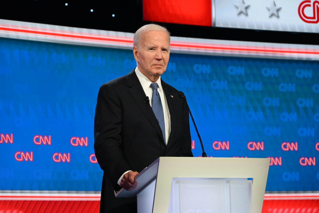 Biden stands at a podium at the CNN debate against Trump.