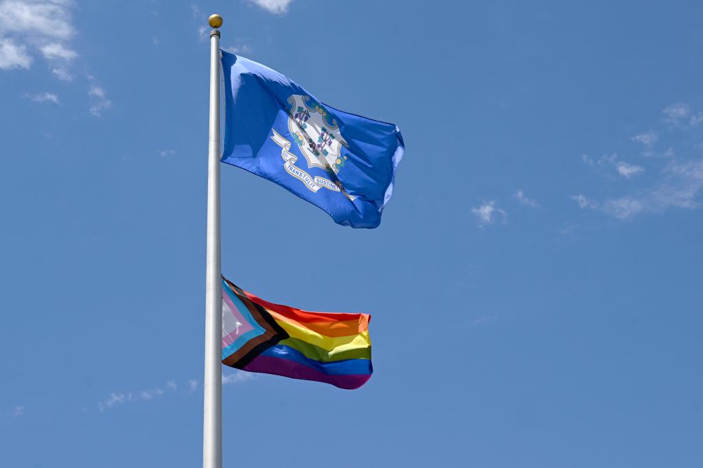 The Pride flag flies at half staff outside of Wethersfield Town Hall on, Friday June 7, 2024, in Wethersfield Conn. 
