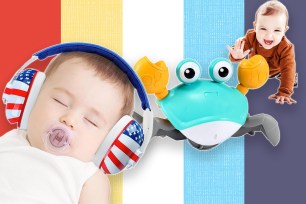 A baby wearing headphones and playing with a toy crab