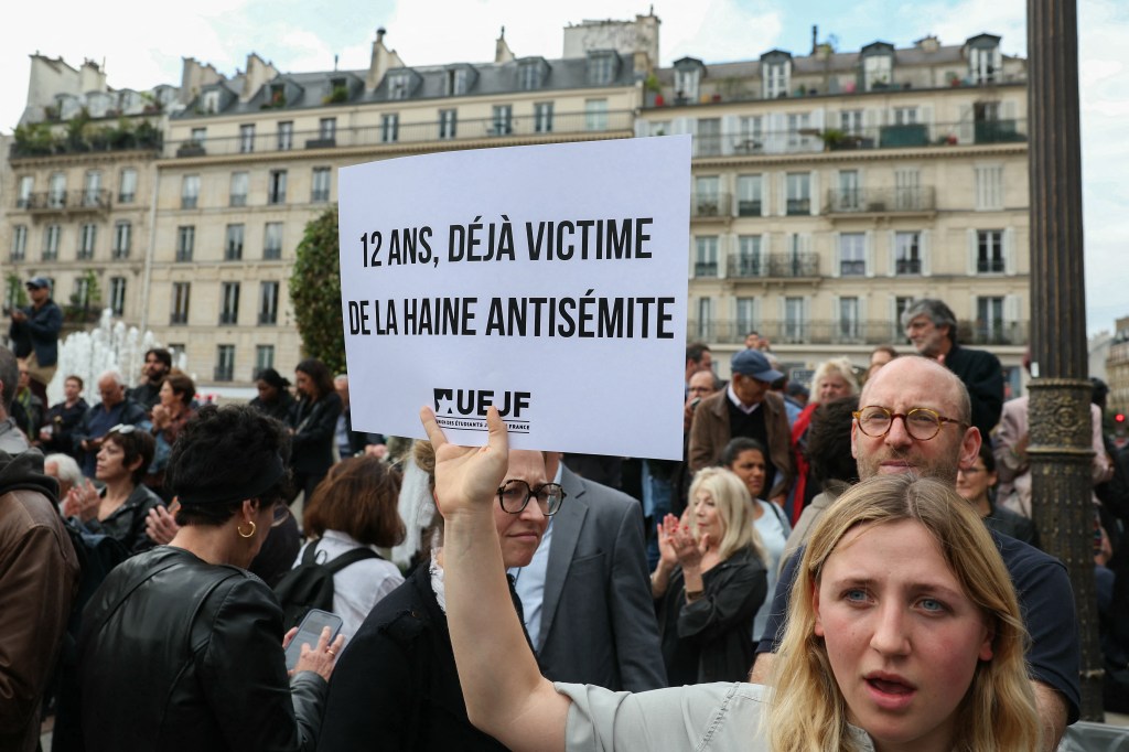 One woman held a sign that read:  "Twelve year-old and already a victim of antisemitic hate."