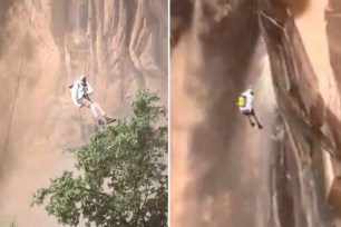 Climber rappels down cliff in Utah.