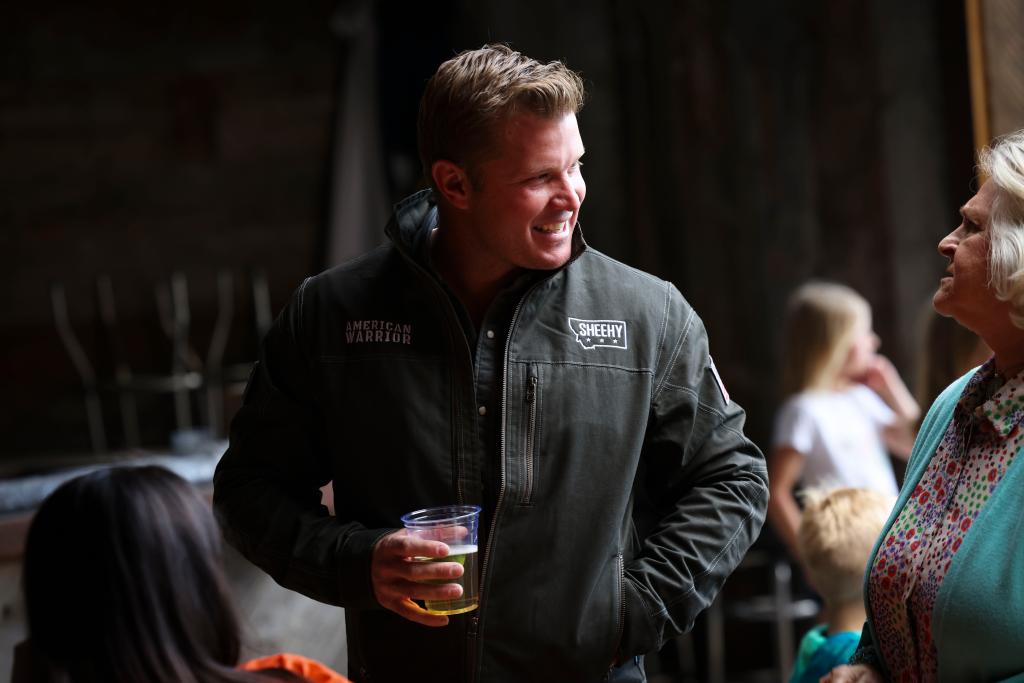 Republican Senate candidate Tim Sheehy in conversation with a supporter at a primary election night party in Gallatin Gateway, Montana, 2024