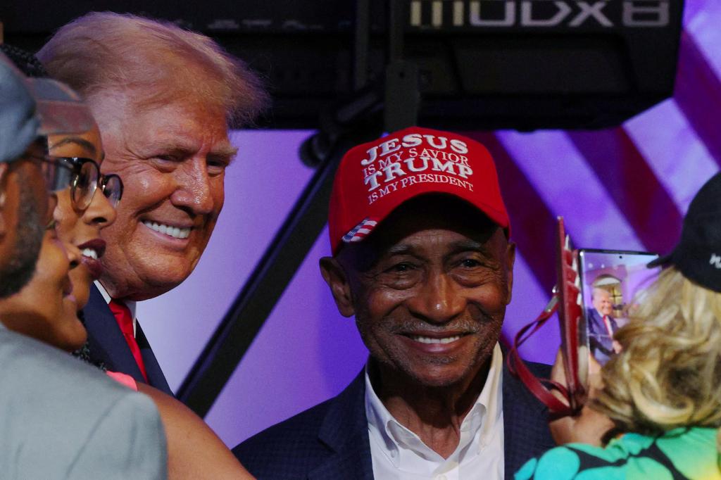 Republican presidential candidate and former U.S. President Donald Trump poses for a photograph with an audience member wearing a hat reading âJesus is my Savior, Trump is my Presidentâ after a campaign 