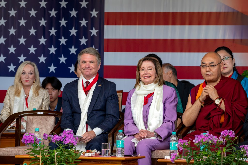 Republican Rep. Michael McCaul, left, and Democratic former House Speaker Nancy Pelosi sit in the front row with Khenpo Sonam Tenphel, Speaker of the Tibetan parliament-in-exile, at a public event during which they were felicitated by the President of the Central Tibetan Administration and other officials at the Tsuglakhang temple in Dharamshala, India, Wednesday, June 19, 2024.
