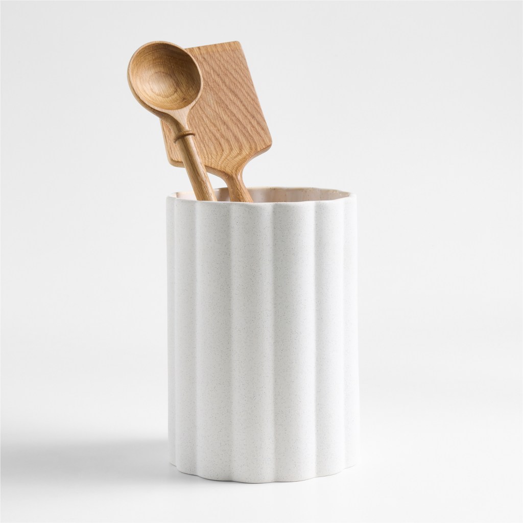 Wooden spoon in a white ceramic scalloped utensil holder by Laura Kim for Crate and Barrel