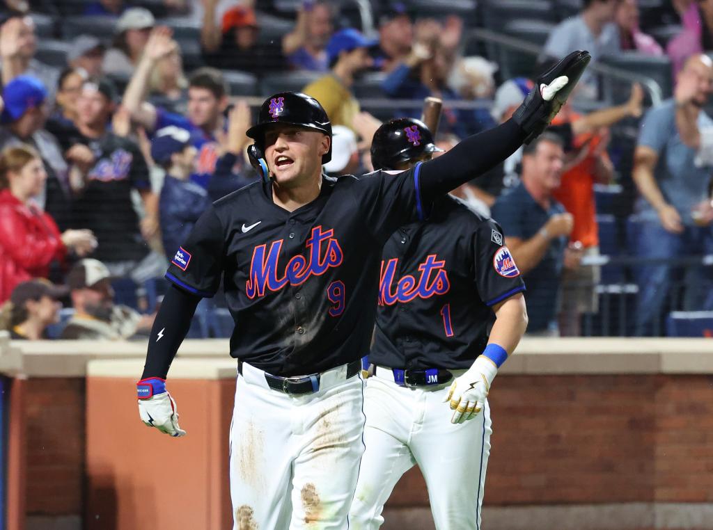 New York Mets outfielder Brandon Nimmo scoring a run on teammate J.D. Martinez's 2-run RBI double during a game against the San Diego Padres at Citi Field