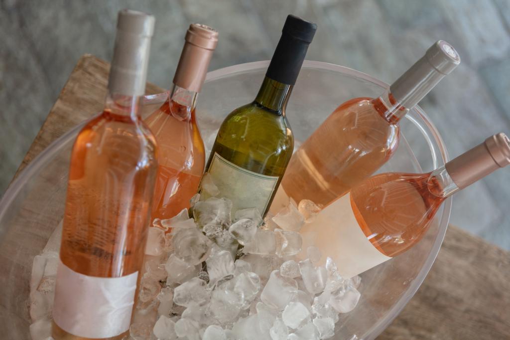 A variety of wine bottles chilling in an ice bucket