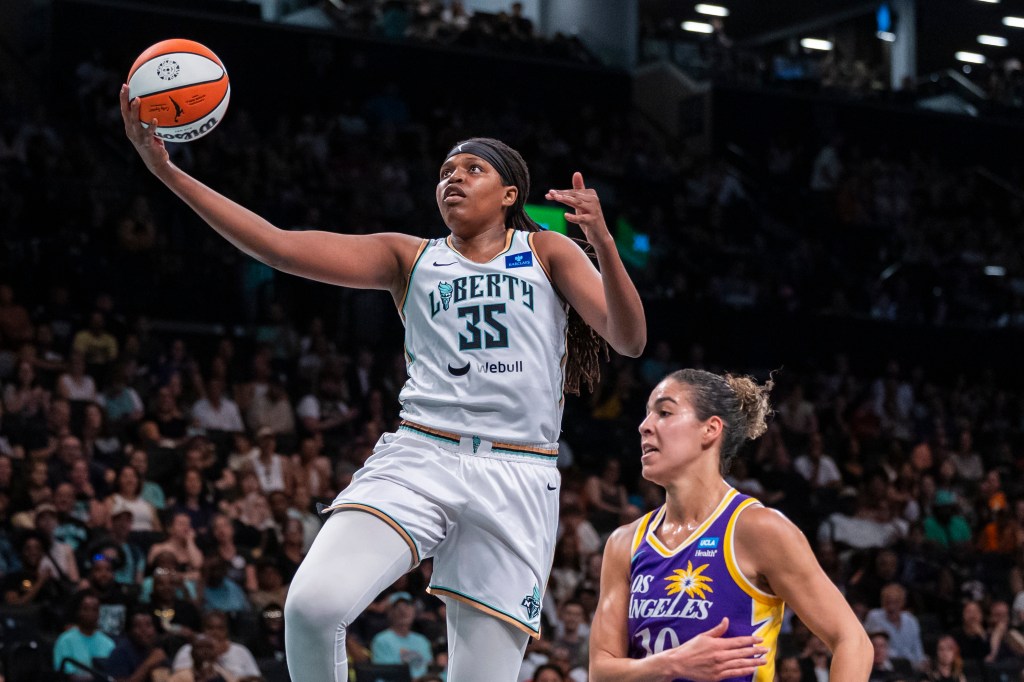 Jonquel Jones (35) shoots a lay up over Los Angeles Sparks guard Kia Nurse (10)  in the first half.