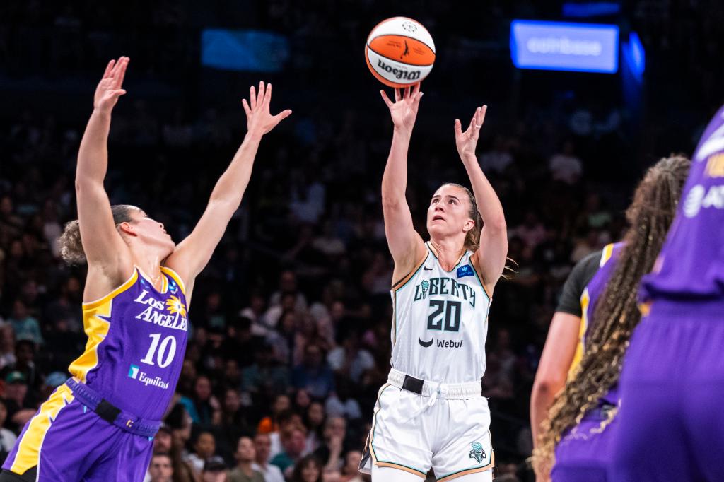 Sabrina Ionescu (20) shoots over Los Angeles Sparks guard Kia Nurse (10) in the first half at Barclays Center.