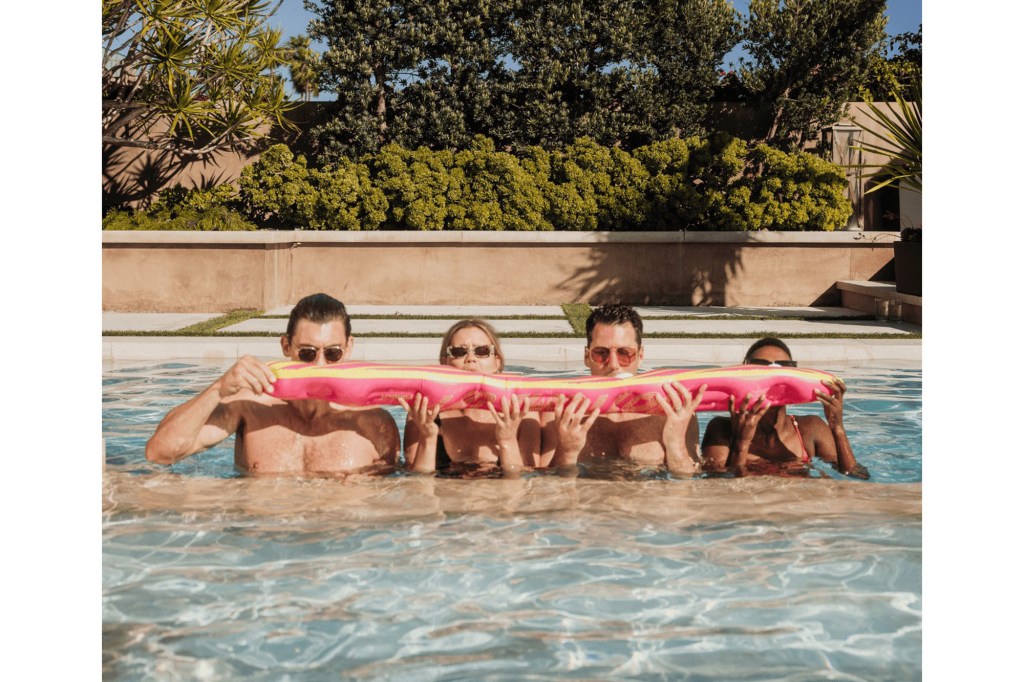 A group of people in a pool holding a float