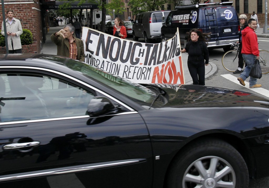 Occupy Wall Street protester Nastaran Mohit shouting at the motorcade of Republican Presidential Candidate Mitt Romney and former Mayor Rudy Giuliani after their visit to a New York firehouse.