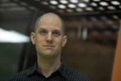 WSJ correspondent Evan Gershkovich stands in a glass cage prior to a hearing in Yekaterinburg's Sverdlovsk Regional Court, Yekaterinburg, Russia, 26 June 2024.