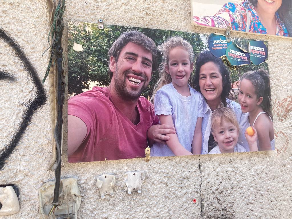 Photo of the Siman Tov family on a wall. 