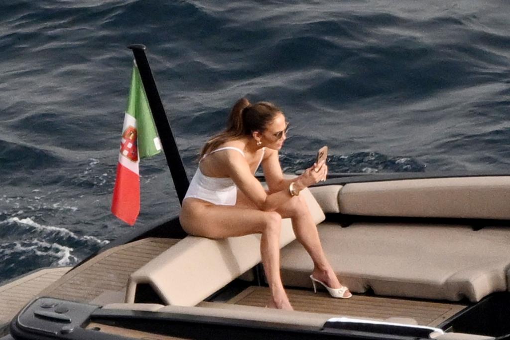 J-Lo on her phone in a bathing suit. 