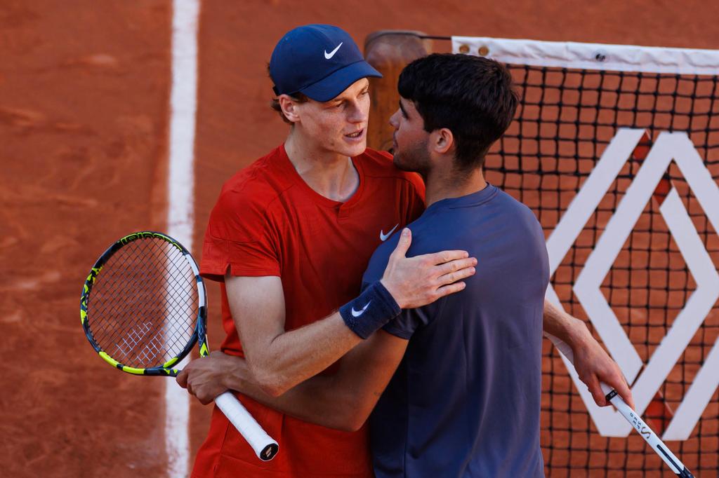Carlos Alcaraz of Spain shakes hands with Jannik Sinner of Italy after beating him in the semi-final of the men's singles at Roland Garros on June 07, 2024 in Paris, France. 