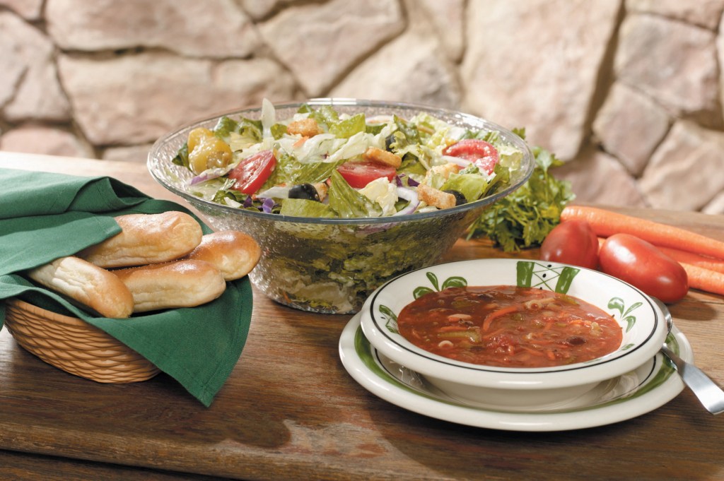 Bowl of salad and soup with breadsticks from Olive Garden