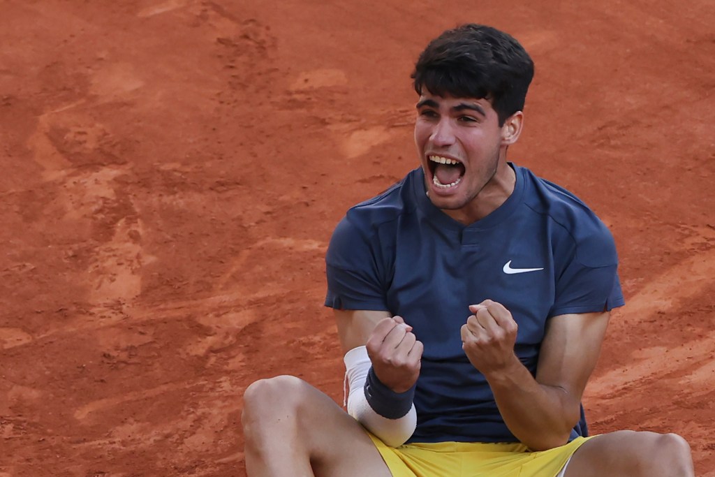 Carlos Alcaraz celebrates after winning the 2024 French Open on Sunday.