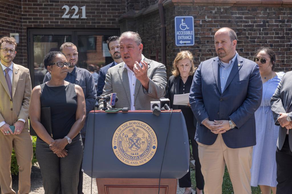 Staten Island Borough President Vito Fossella (center) speaks to the press alongside Councilwoman Kamillah Hanks (left), Councilman David Carr (right) and other community leaders and representatives outside Faith United Methodist Church on Monday. 