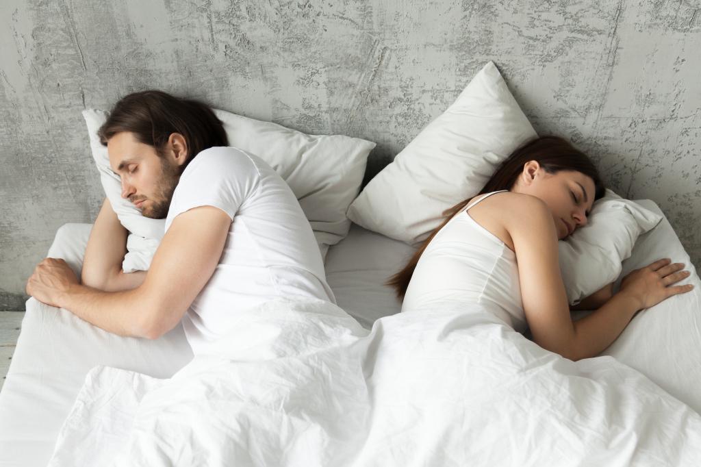 man and woman sleeping not facing each other