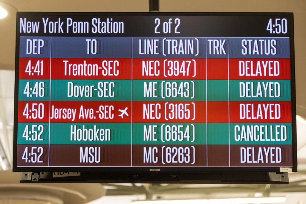 A sign at Penn Station announcing all the delays and cancellations.