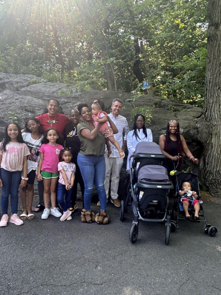 Ari Nagel stands at the Bronx Zoo alongside five of his baby mamas and at least six of their shared children