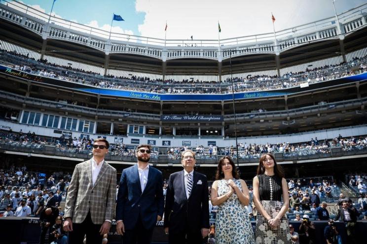Recently retired Yankee announcer, John Sterling (center) surrounded by his children (left to right) Brad, Derek, Abigail, and Veronica on the field at Yankee Stadium.