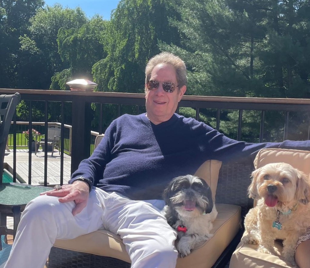 A photo of John Sterling with two family dogs.