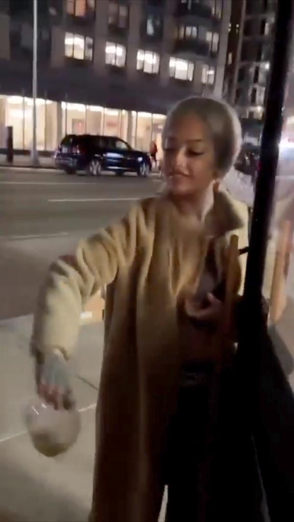 Screenshot of video showing a blonde woman throwing bowl of soup at Hummus Kitchen staffer