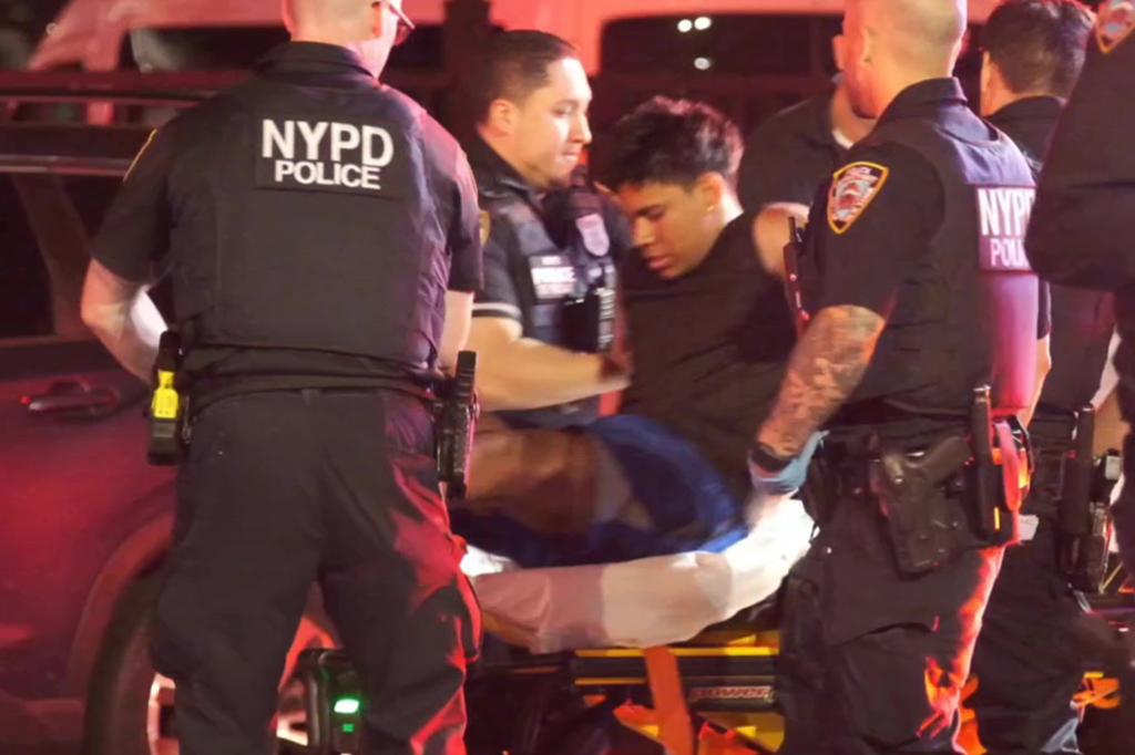 Suspect Bernardo Castro Mata sits on a stretcher accompanied by NYPD officers.